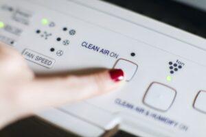 Close Up Hand Turning On Air Purifier